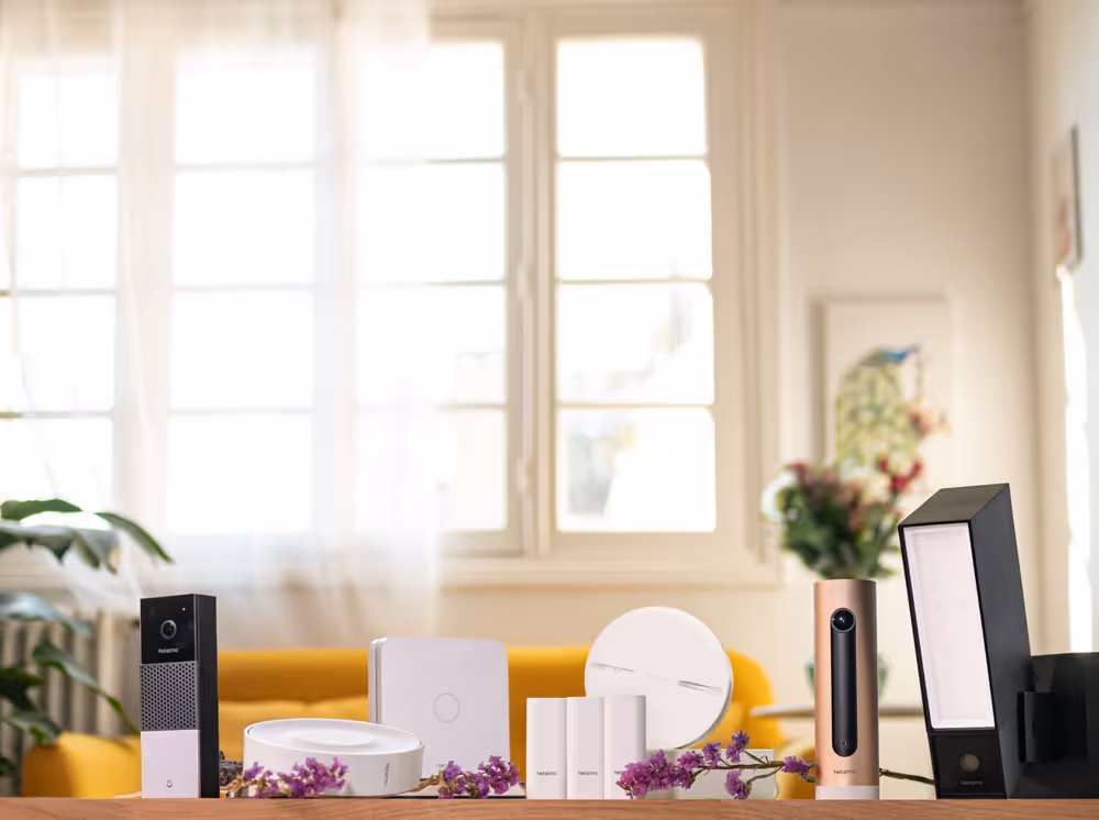 Table with Netatmo products and flowers